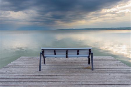 Bench on Wooden Jetty at Sunset at Weiden am See, Lake Neusiedl, Burgenland, Austria Stock Photo - Premium Royalty-Free, Code: 600-08783099