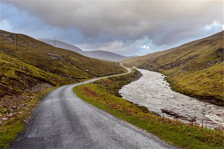Winding road with river and cloudy sky in the highlands at Glen Coe in Scotland, United Kingdom Photographie de stock - Premium Libres de Droits, Code: 600-08973451