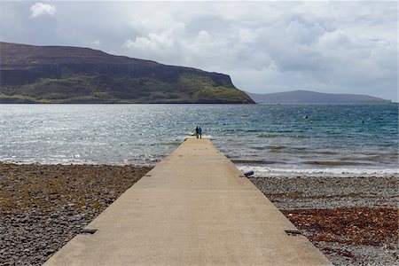 simsearch:851-02963762,k - Concrete pier with couple looking at view of the sea on a sunny day on the Isle of Skye in Scotland, United Kingdom Stock Photo - Premium Royalty-Free, Code: 600-08986313