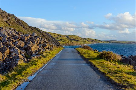 Typical Scottish landscape of the Isle of Sky with a coastal road and sea cliffs on a sunny day in Scotland, United Kingdom Stock Photo - Premium Royalty-Free, Code: 600-08986464