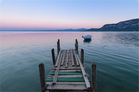 Old wooden jetty on the Lake Garda (Lago di Garda) at dawn in Garda in Veneto, Italy Stock Photo - Premium Royalty-Free, Code: 600-09022392