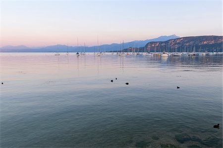 simsearch:600-09022400,k - Lake Garda (Lago di Garda) with anchored sailboats at dawn in Bardolino in Veneto, Italy Stock Photo - Premium Royalty-Free, Code: 600-09022421