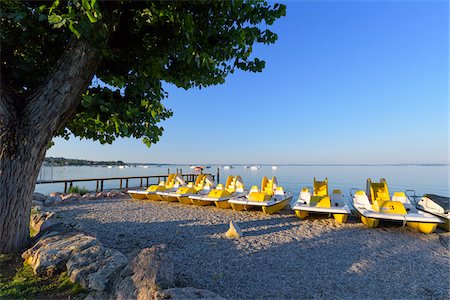 simsearch:600-09022396,k - Row of colorful pedal boats on the beach in the morning at Lake Garda (Lago di Garda) in Bardolino in Veneto, Italy Foto de stock - Sin royalties Premium, Código: 600-09022434