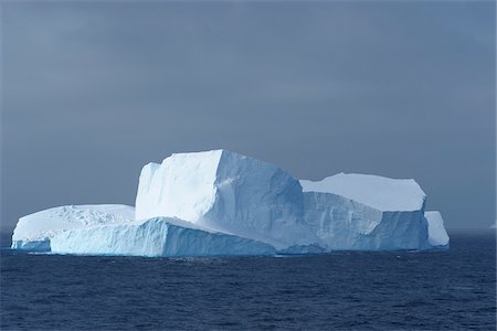 Sunlit iceberg in the dark blue waters of the Antarctic Sound at the Antarctic Peninsula, Antarctica Stock Photo - Premium Royalty-Free, Code: 600-09052805