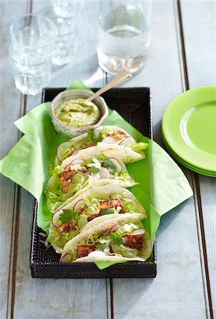 simsearch:600-06397672,k - Serving tray of fish tacos with guacamole and side plates Stock Photo - Premium Royalty-Free, Code: 600-09119448