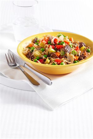 simsearch:600-09159794,k - Fried Rice with pieces of beef, peppers, peas, celery, mushrooms and onion in a yellow bowl Stock Photo - Premium Royalty-Free, Code: 600-09119449