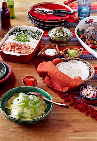 simsearch:600-05855245,k - Mexican holiday feast with roast pork and dishes of rice, salad and tortillas Foto de stock - Sin royalties Premium, Código: 600-09119442