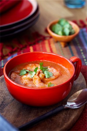 simsearch:600-09159766,k - Tomato and shrimp soup in a red bowl topped with cilantro Stock Photo - Premium Royalty-Free, Code: 600-09119482