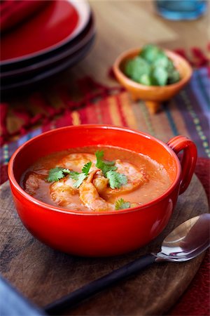 simsearch:600-09159794,k - Tomato and shrimp soup in a red bowl topped with cilantro Stock Photo - Premium Royalty-Free, Code: 600-09119482