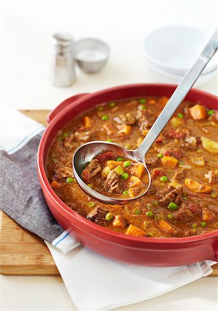 food on stainless steel - Beef stew with celery, peas, and sweet potatos, in red pan Stock Photo - Premium Royalty-Free, Code: 600-09155464