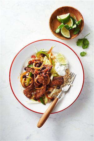 simsearch:600-07156143,k - Steak fajita dinner on a plate with lime wedges and sour cream Stock Photo - Premium Royalty-Free, Code: 600-09155547