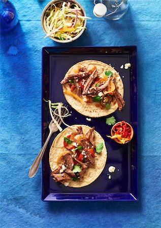 shredded - Beef Tacos on a blue platter with a side dish of coleslaw Stock Photo - Premium Royalty-Free, Code: 600-09155554