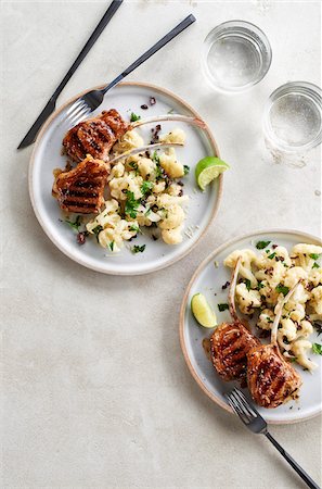 simsearch:600-08002141,k - Two plates of grilled lamb chops with cauliflower salad on a grey background Stock Photo - Premium Royalty-Free, Code: 600-09155573