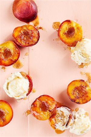 simsearch:600-06486072,k - Roasted peaches with vanilla ice cream and syrup on a peach background Stock Photo - Premium Royalty-Free, Code: 600-09155582