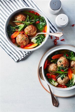 Bowls of Asian chicken meatballs in broth with vegetables Stock Photo - Premium Royalty-Free, Code: 600-09159766