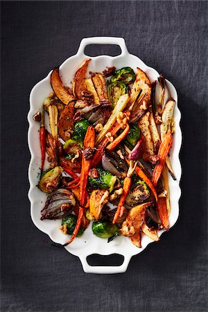 food, dark background - Roasted vegetables on a white platter on a dark linen tablecloth, black background Stock Photo - Premium Royalty-Free, Code: 600-09159774