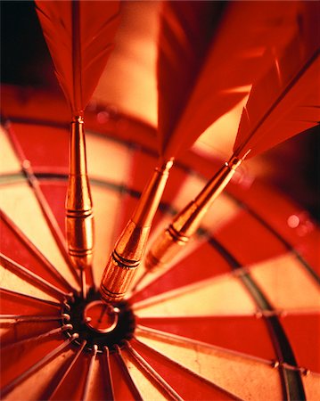 Close-Up of Darts in Bull's-Eye Of Dartboard Stock Photo - Premium Royalty-Free, Code: 600-00034232