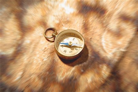 Compass on Blurred Stone Surface Foto de stock - Royalty Free Premium, Número: 600-00058049