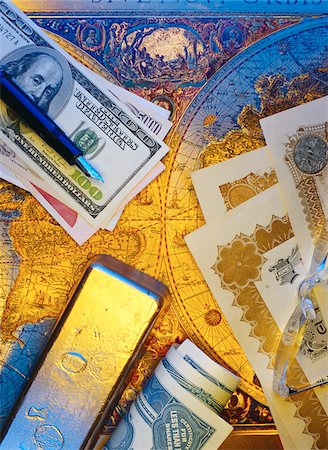 International Currency, Pen Stock Certificates and Gold Bar On Antique World Map Stock Photo - Premium Royalty-Free, Code: 600-00065083