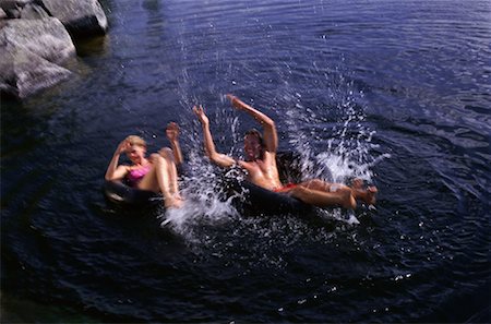 radius images couple swimming lake - Couple Playing in Inner Tubes on Lake, Belgrade Lakes, Maine, USA Stock Photo - Premium Royalty-Free, Code: 600-00068098