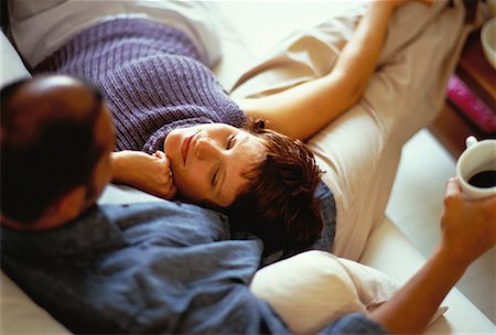 Close-Up of Couple Relaxing on Sofa Stock Photo - Premium Royalty-Free, Code: 600-00061969