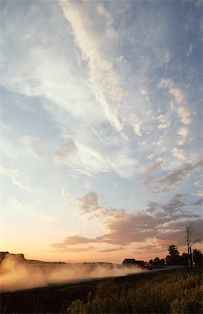 Back View of Truck Leaving Dust Trail at Sunset Stock Photo - Premium Royalty-Free, Code: 600-00074250