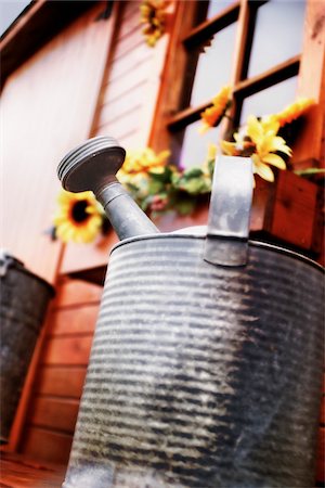 Close-Up of Watering Can on Porch Stock Photo - Premium Royalty-Free, Code: 600-00074885