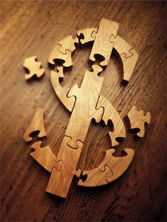 photograph of still life - Wooden Jigsaw Puzzle Forming Dollar Sign Stock Photo - Premium Royalty-Free, Code: 600-00070675
