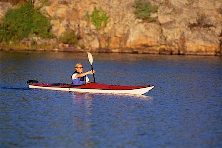 Man Kayaking on Lake, Haliburton, Ontario, Canada Stock Photo - Premium Royalty-Free, Code: 600-00071233