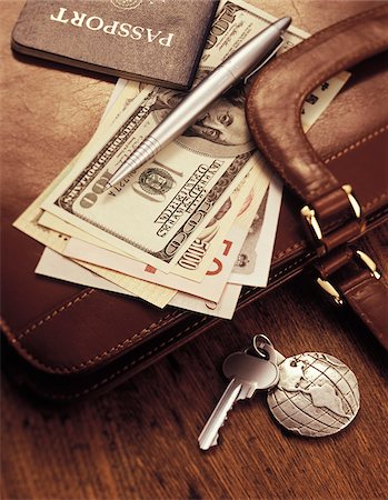 International Currency, Pen and Passport on Briefcase Stock Photo - Premium Royalty-Free, Code: 600-00072411