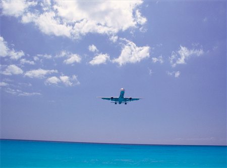 plane sky cloud looking up not people - Plane over Water Stock Photo - Premium Royalty-Free, Code: 600-00174947