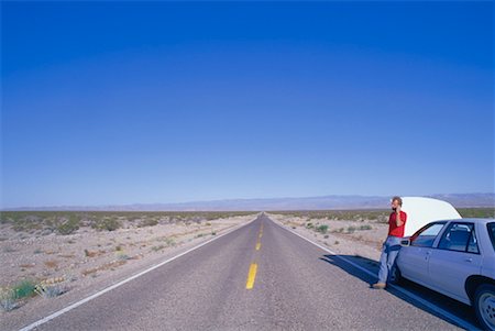 Person on Cell Phone by Stranded Car, Nevada, USA Stock Photo - Premium Royalty-Free, Code: 600-00171303