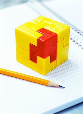 puzzle concept not person - Cube Puzzle and Pencil on Notebook Stock Photo - Premium Royalty-Free, Code: 600-00199211