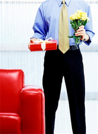 surprising man - Man with Roses and Gift Stock Photo - Premium Royalty-Free, Code: 600-00357668