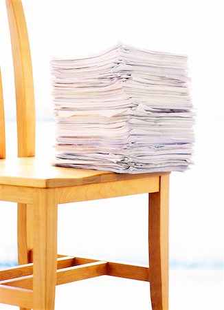 paper stack on white background - Stack of Papers on Chair Stock Photo - Premium Royalty-Free, Code: 600-00357676