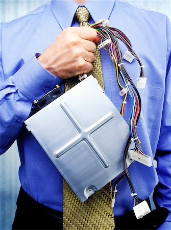 Businessman Holding Unplugged Hard Drive Stock Photo - Premium Royalty-Free, Code: 600-00362042