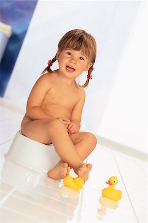 Potty Training. Little cute child girl sitting on a toilet. Stock Photo