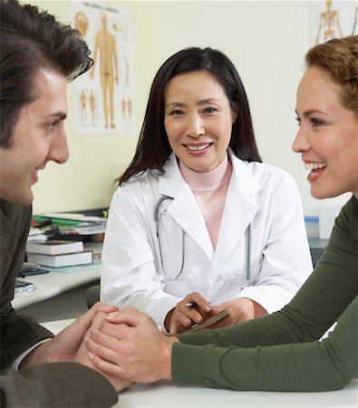 doctor with ethnic patient in office - Doctor With Patients Stock Photo - Premium Royalty-Free, Code: 600-00795755