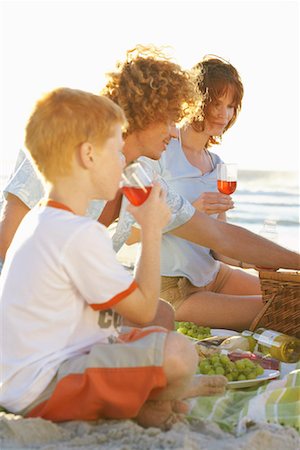 summertime picnic with family in the beach - Family Having Picnic Stock Photo - Premium Royalty-Free, Code: 600-00796474