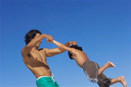 dad spinning child - Father and Son Playing Outdoors Stock Photo - Premium Royalty-Free, Code: 600-00796504