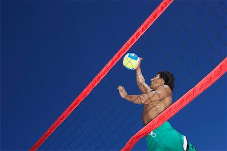 Man Playing Beach Volleyball Fotografie stock - Premium Royalty-Free, Codice: 600-00796517