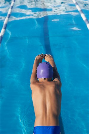 swimming kid in swimming cap photos - Boy Diving into Swimming Pool Stock Photo - Premium Royalty-Free, Code: 600-00814559