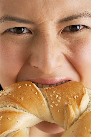 people eating bagels - Woman Eating Bagel Stock Photo - Premium Royalty-Free, Code: 600-00823957