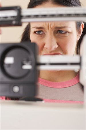 sad people on weighing scales - Woman on Scale Stock Photo - Premium Royalty-Free, Code: 600-00846107