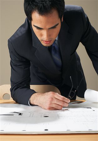 simsearch:600-00823179,k - Businessman Looking at Blueprints Fotografie stock - Premium Royalty-Free, Codice: 600-00846237