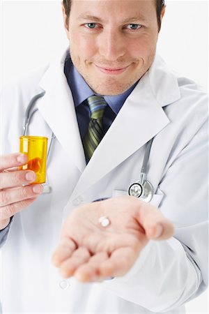 pill bottle in hand - Portrait of Doctor Holding Pill Bottle and Pill Stock Photo - Premium Royalty-Free, Code: 600-00846371