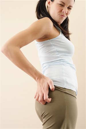 Woman Scratching Buttocks Stock Photo - Premium Royalty-Free, Code: 600-00848081