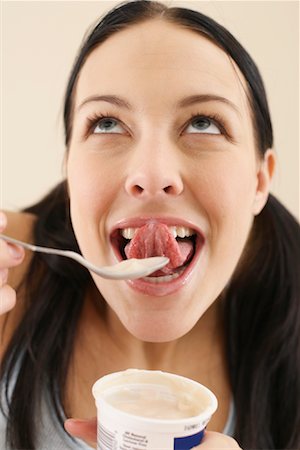 Woman Eating Yogurt Stock Photo - Premium Royalty-Free, Code: 600-00848083