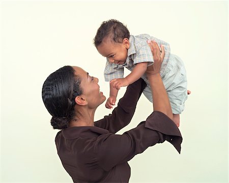 pictures of black families at play - Woman Holding Baby Stock Photo - Premium Royalty-Free, Code: 600-00864405