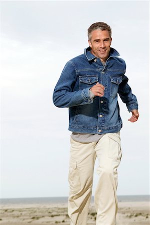 picture of 50 year old man running - Man Running on Beach Stock Photo - Premium Royalty-Free, Code: 600-00864499